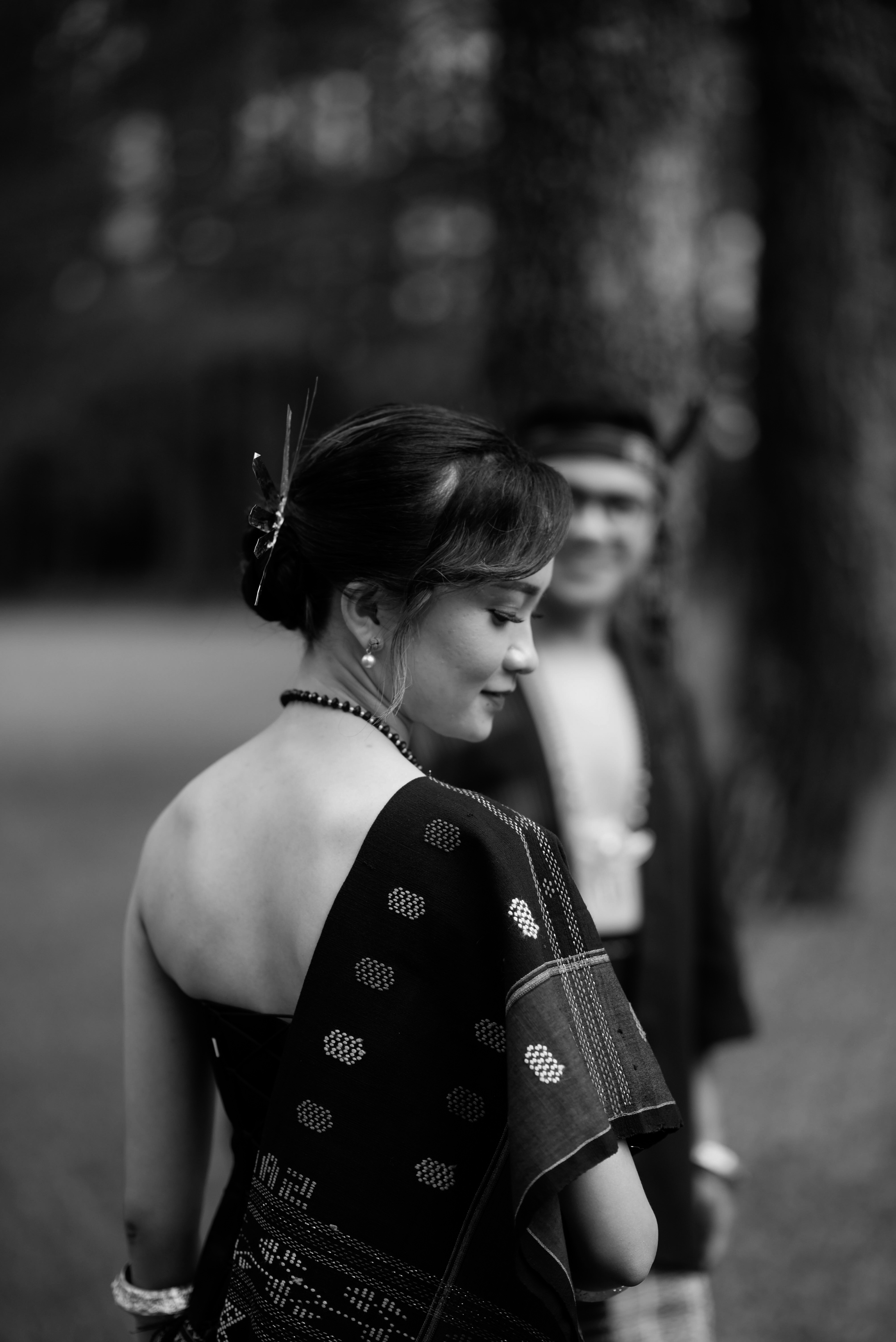 A couple in traditional attire pose together.