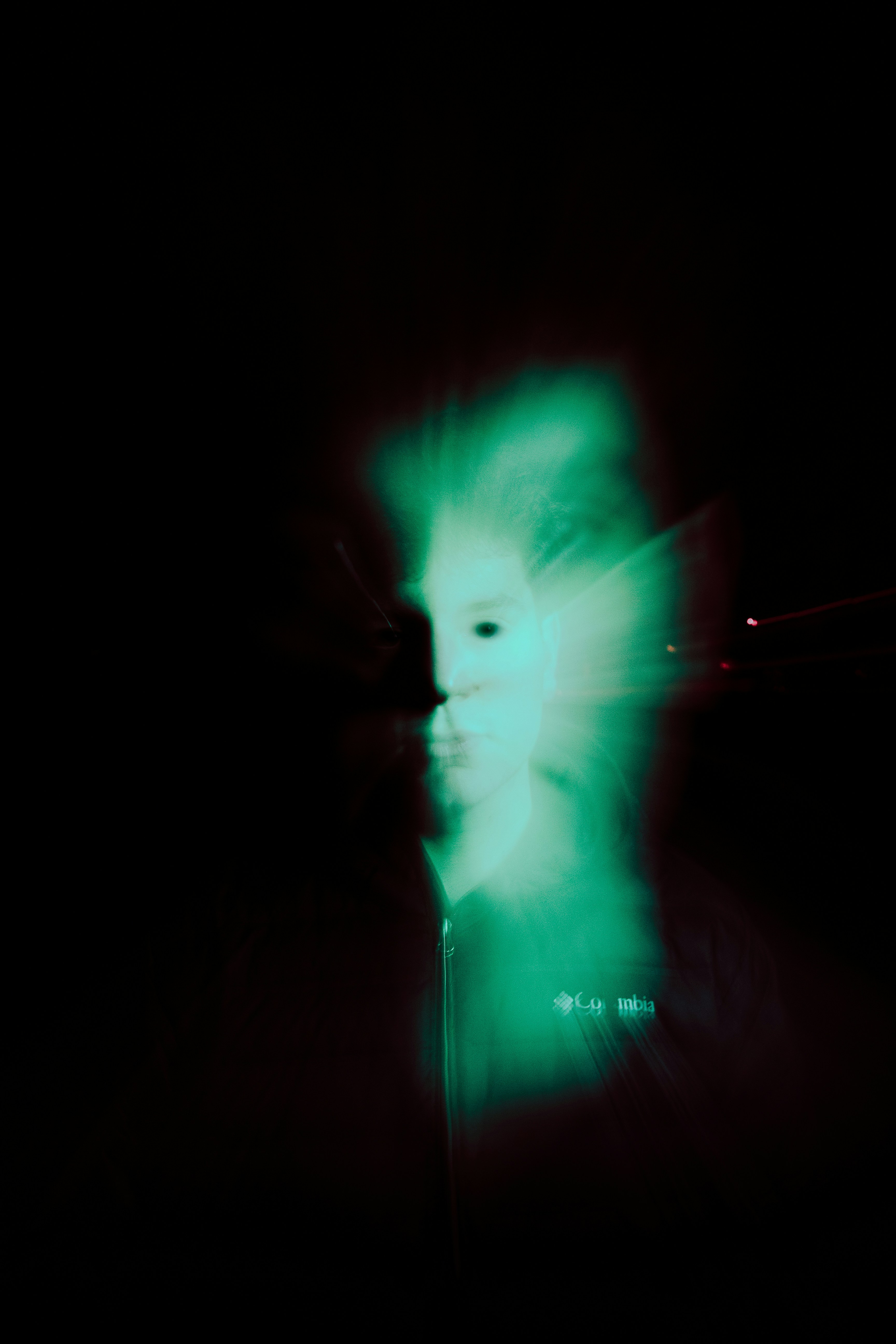 A green and blurry face is visible.