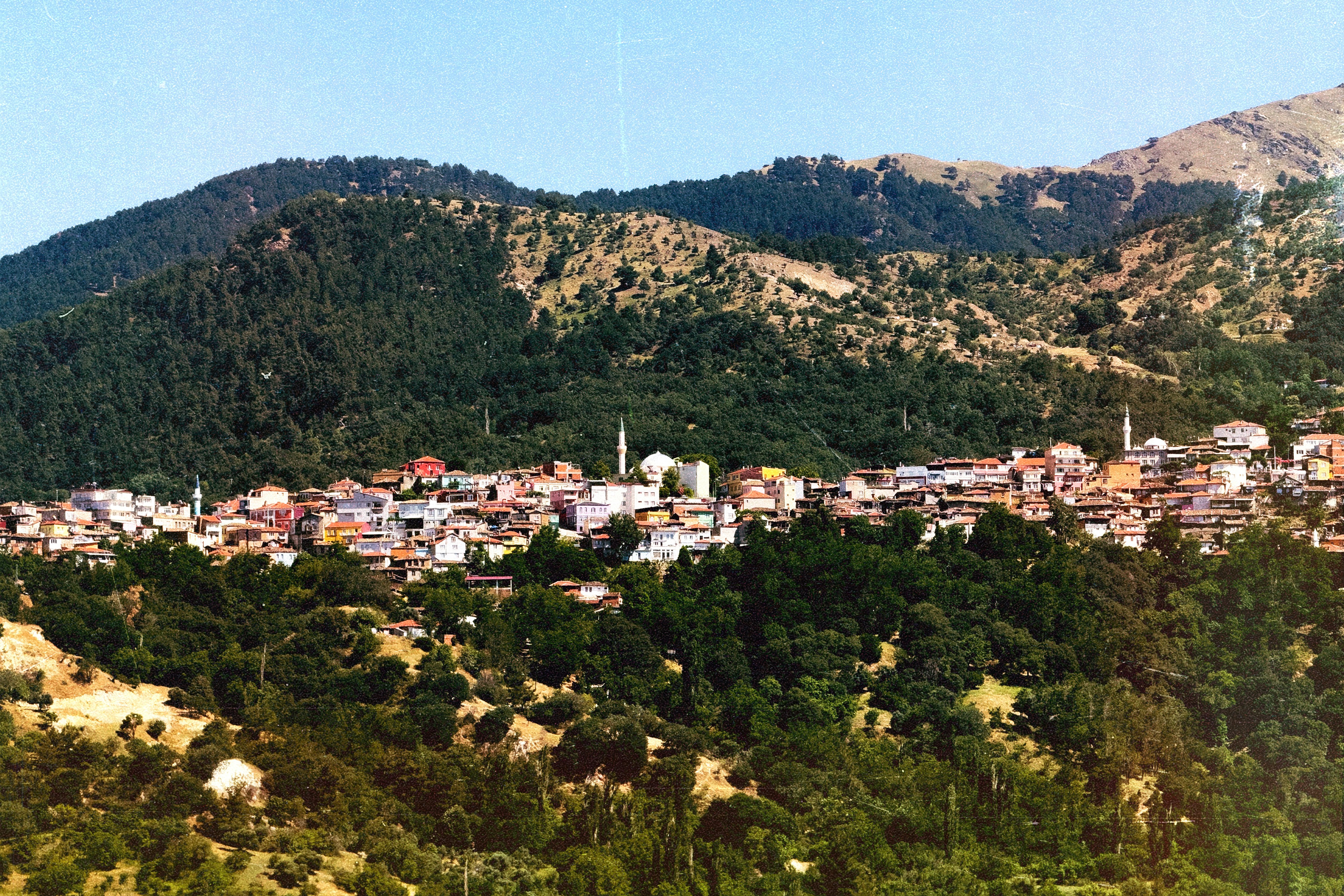 A mountain town nestled amongst forested hills.