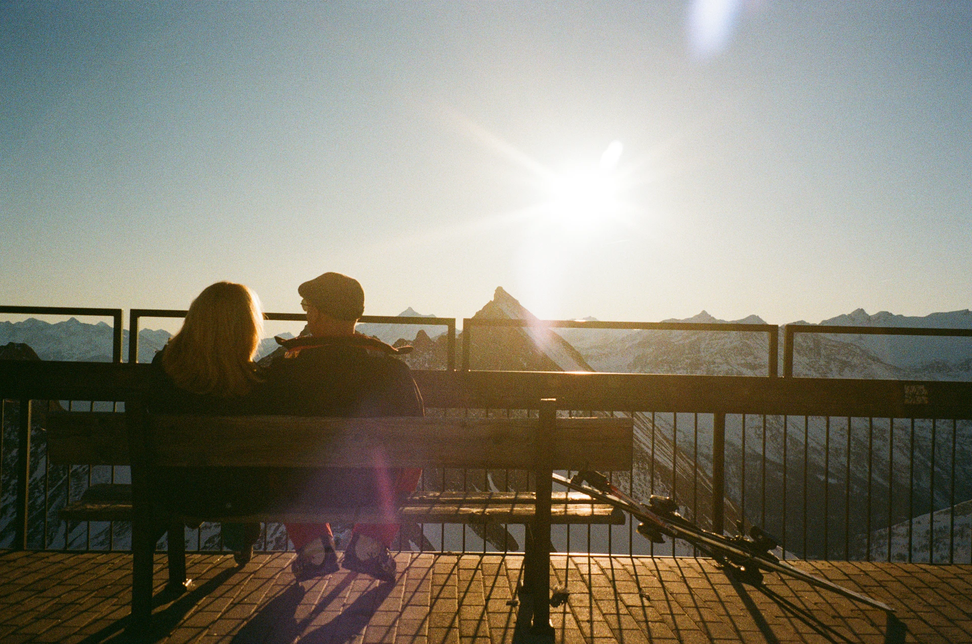 Couple enjoying a sunset view from a mountain overlook