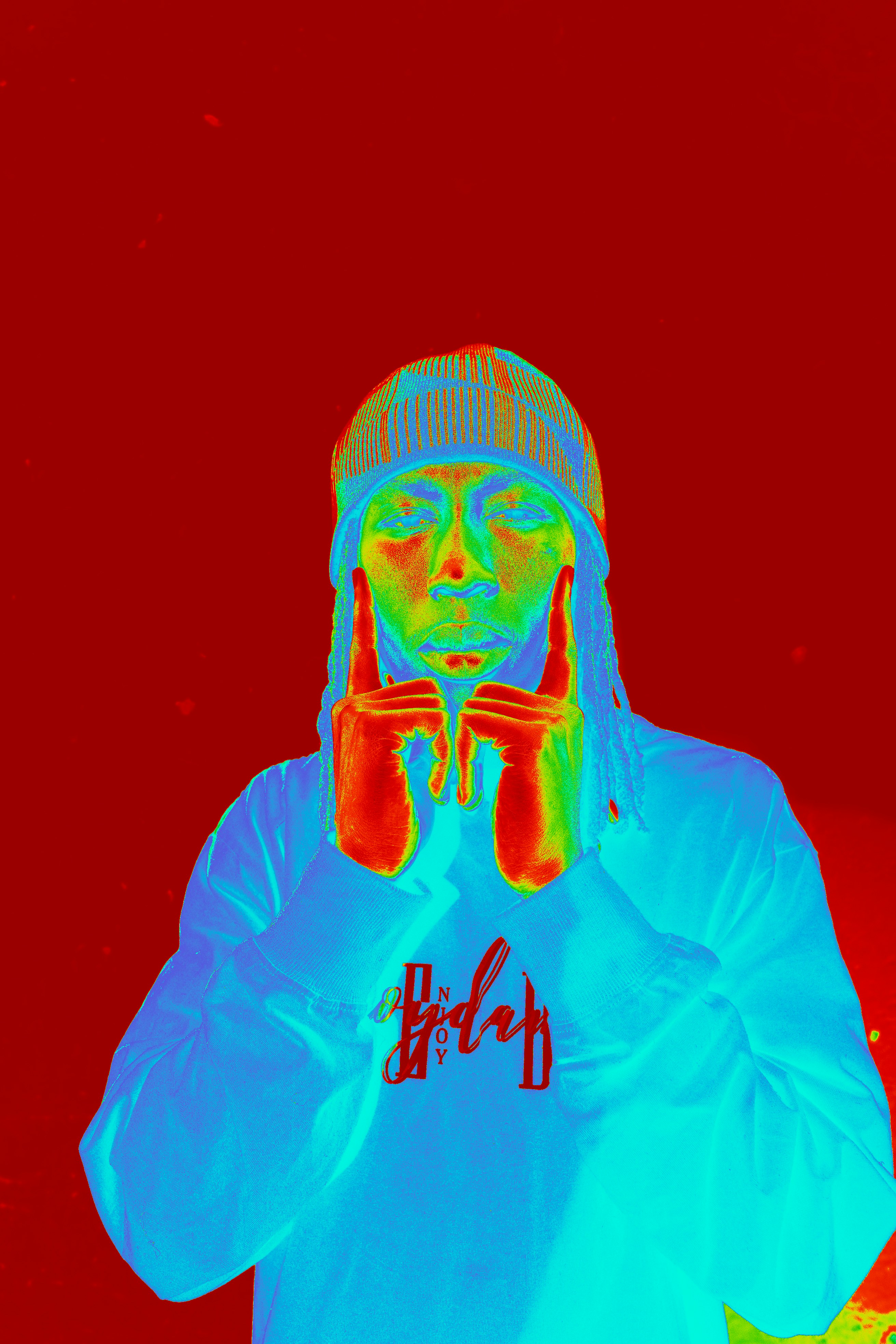 Person poses with hands near face, vivid colors.