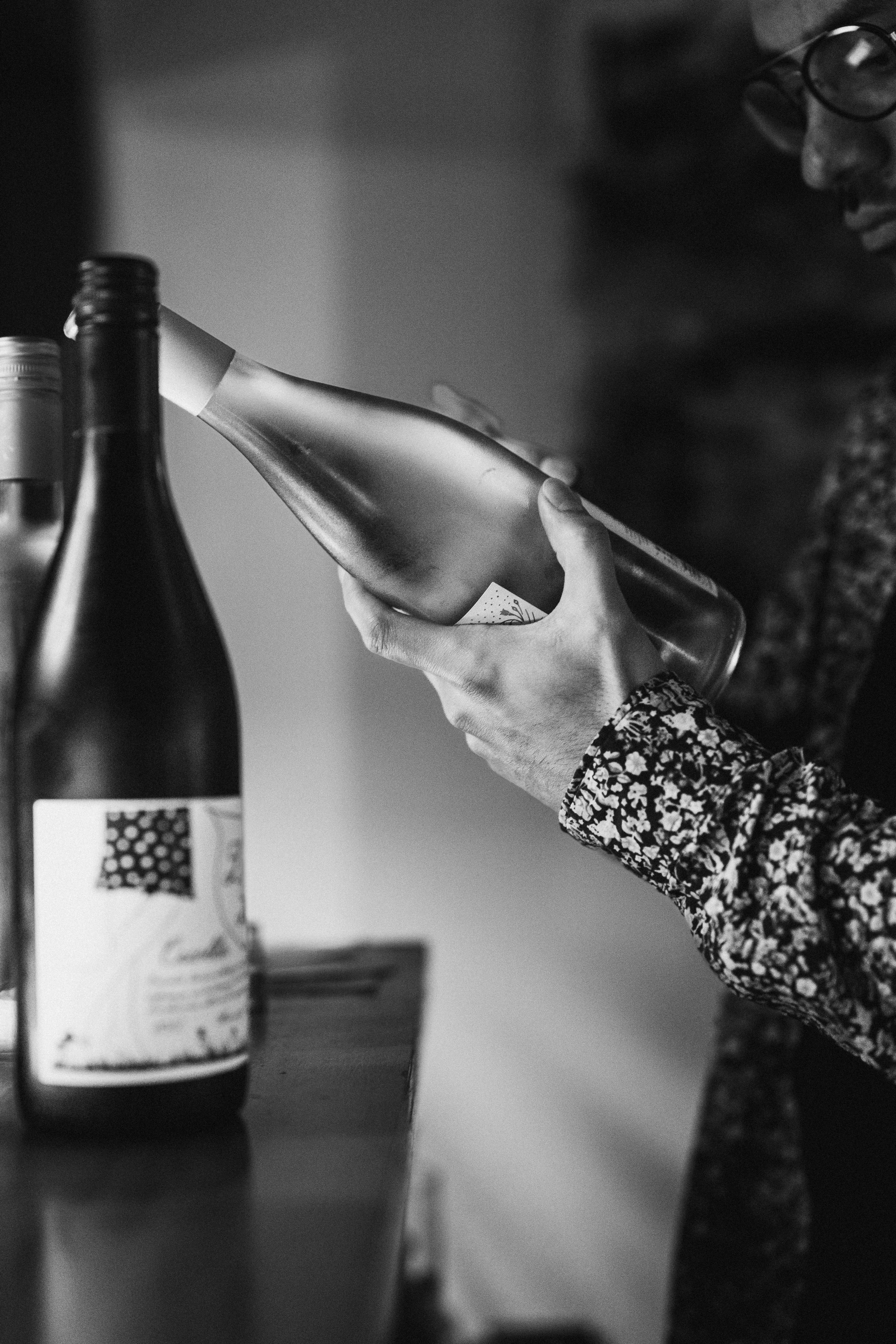 Man examines a bottle of wine.