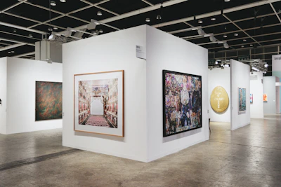 Art is displayed in a modern gallery space.
