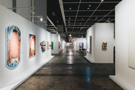 A long gallery hallway with various art displays.