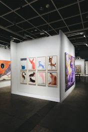 Art gallery displays various colorful animal paintings.