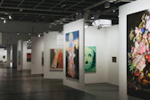 An art gallery showcases various paintings on display.