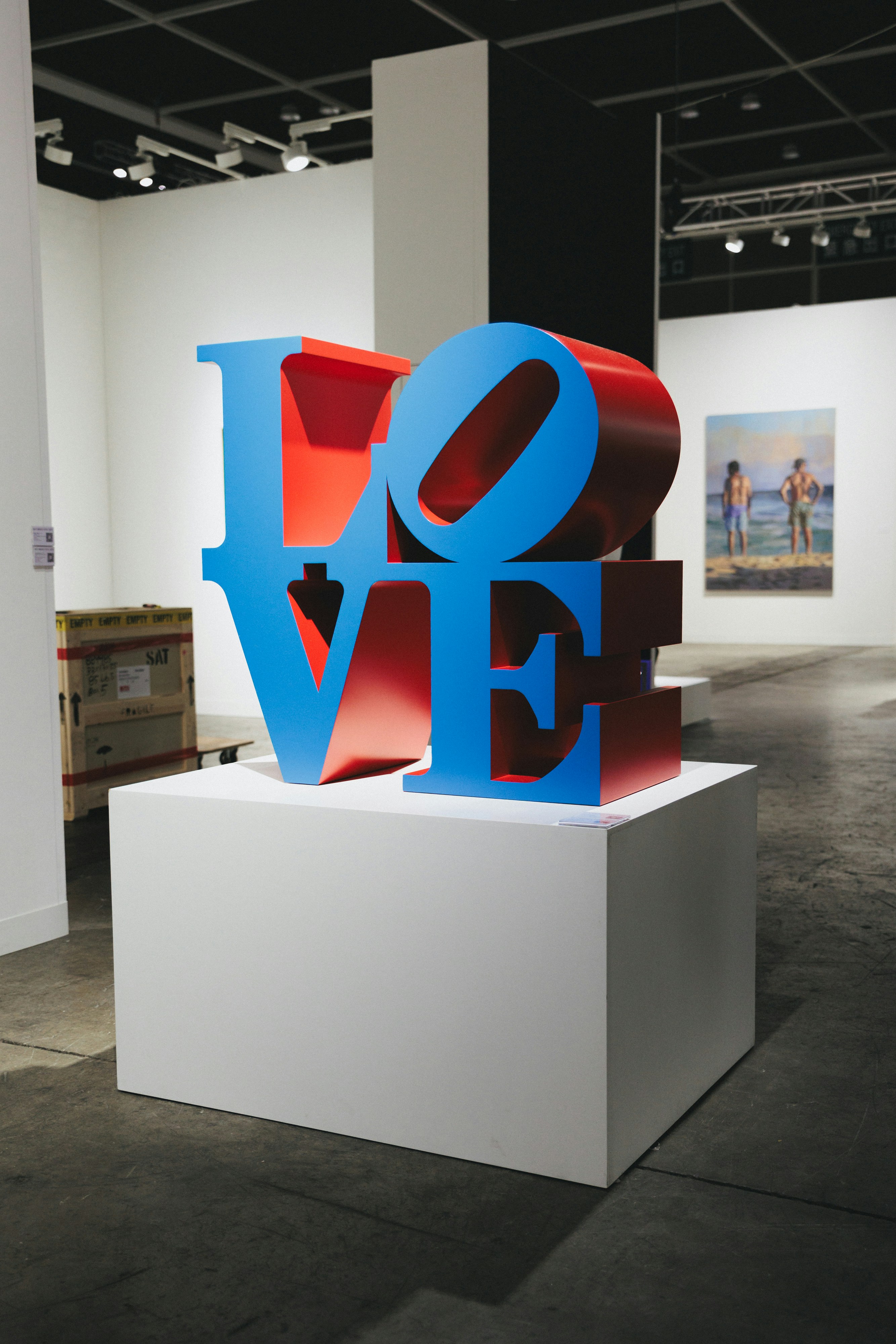 An "love" sculpture in an art gallery.