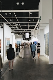 People view artwork at an art gallery.