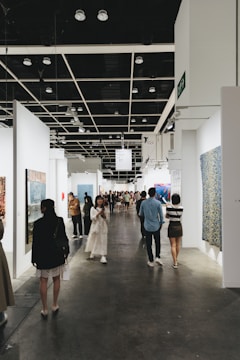 People view artwork at an art gallery.