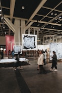 People are viewing art pieces in a gallery.