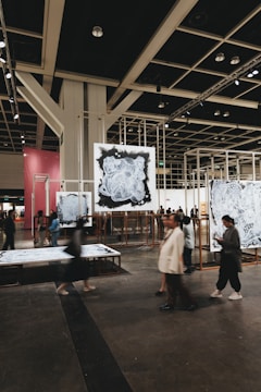 People are viewing art pieces in a gallery.