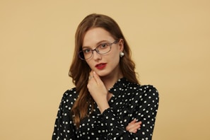 A woman is wearing glasses and posing for a photo.