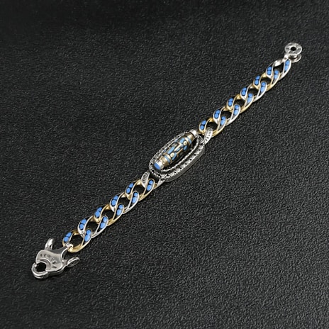 A blue and gold chain bracelet is displayed.