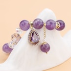A beautiful purple bead bracelet with charm.