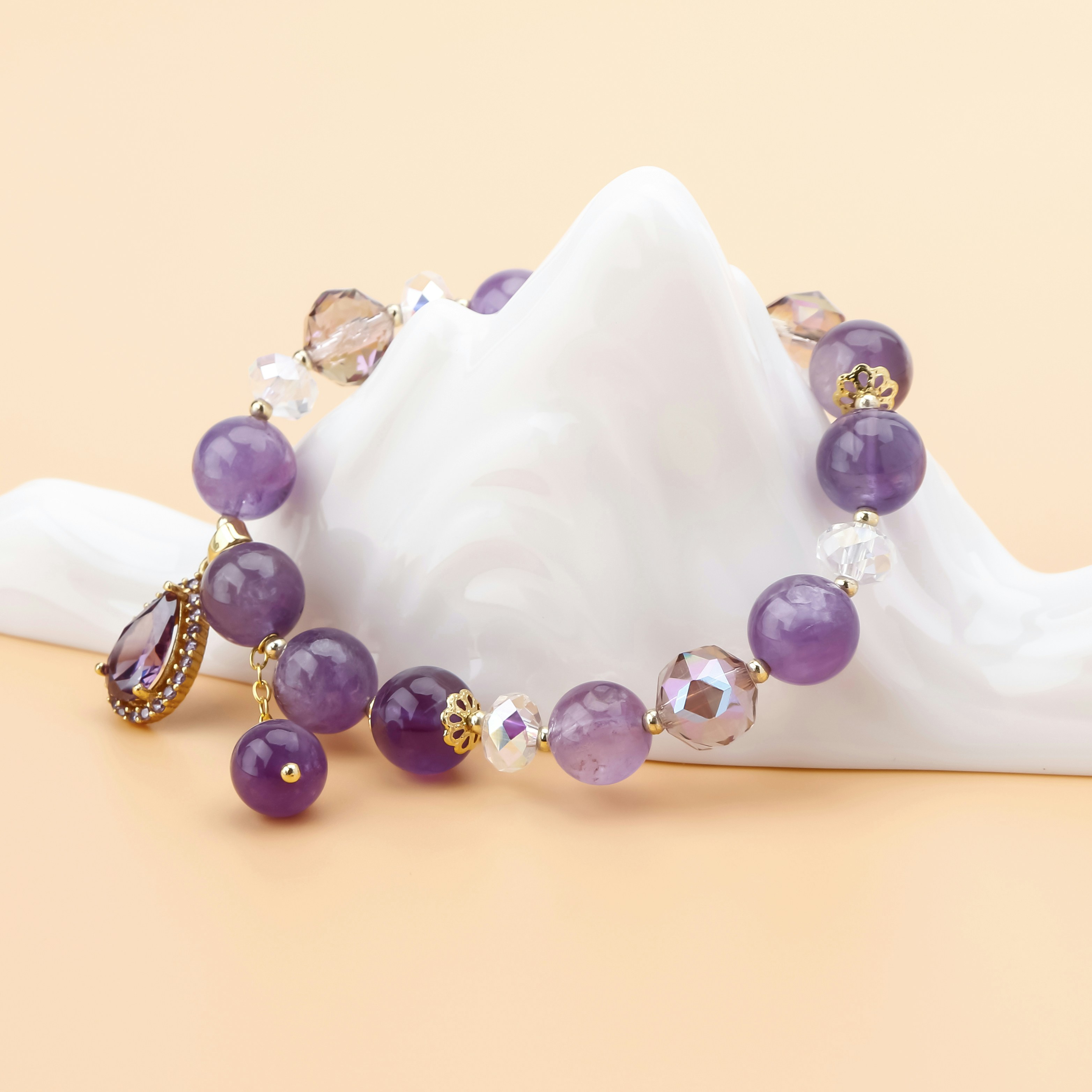 A purple beaded bracelet is displayed.