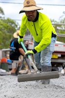 Man levels wet cement with a concrete float.