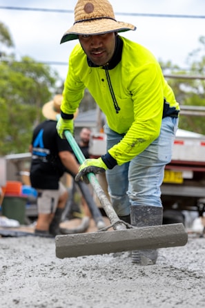 Man levels wet cement with a concrete float.