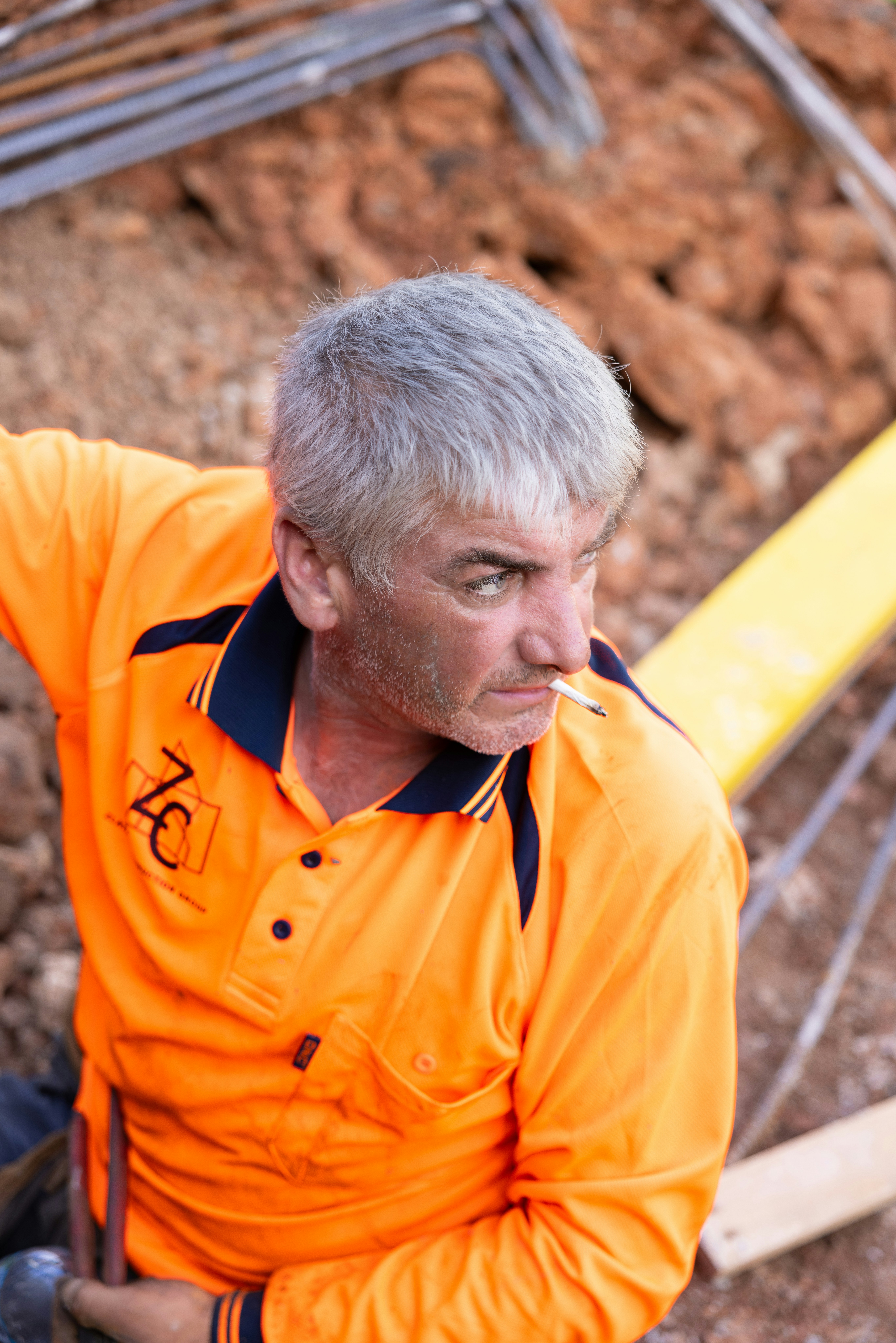 A construction worker pauses for a smoke break.