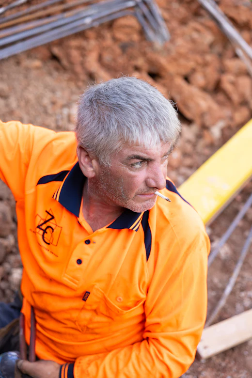 A tradesperson in hi-vis on site