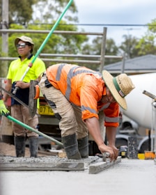 Construction workers are leveling concrete.