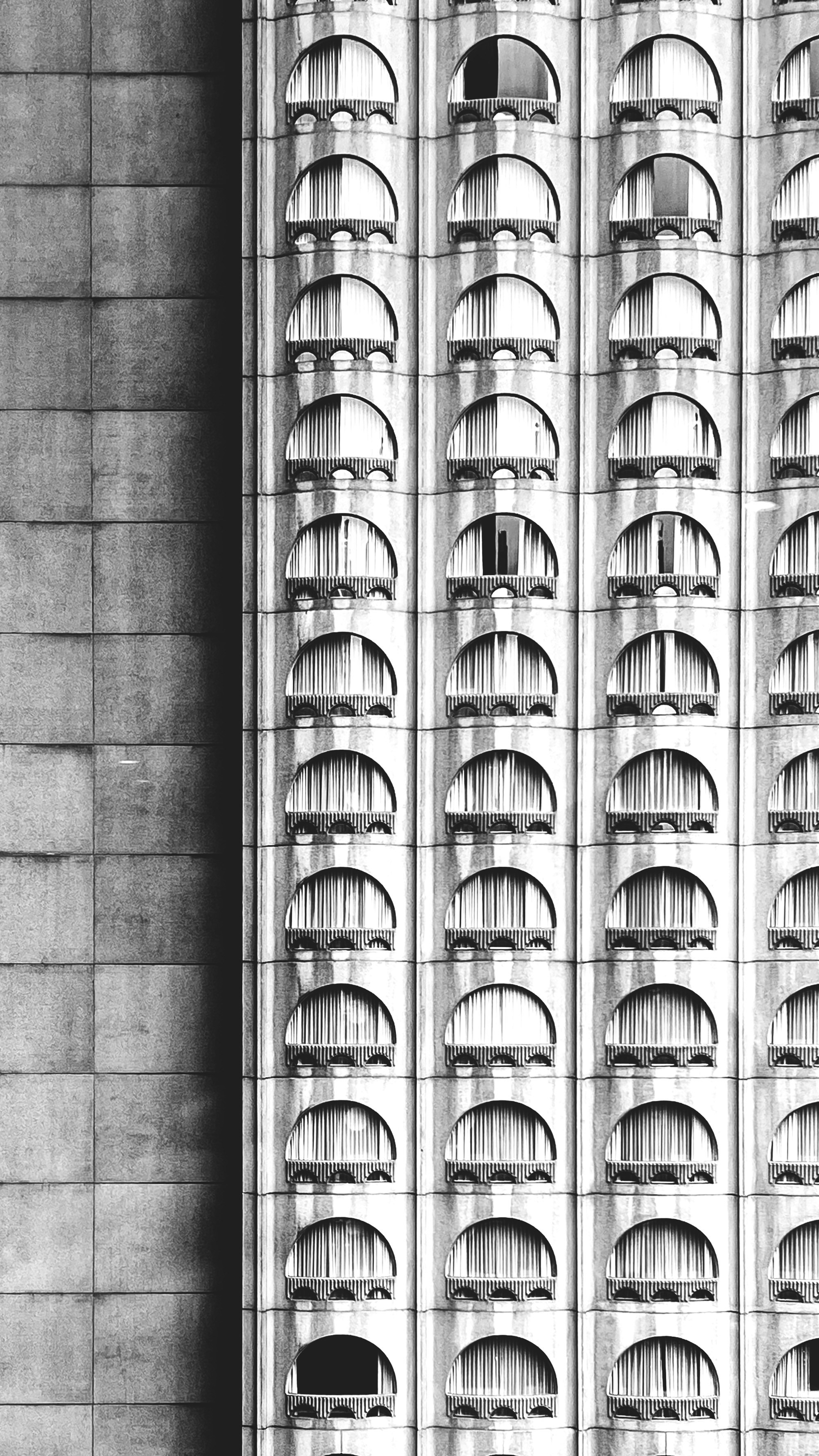 A building's facade with semi-circular windows.