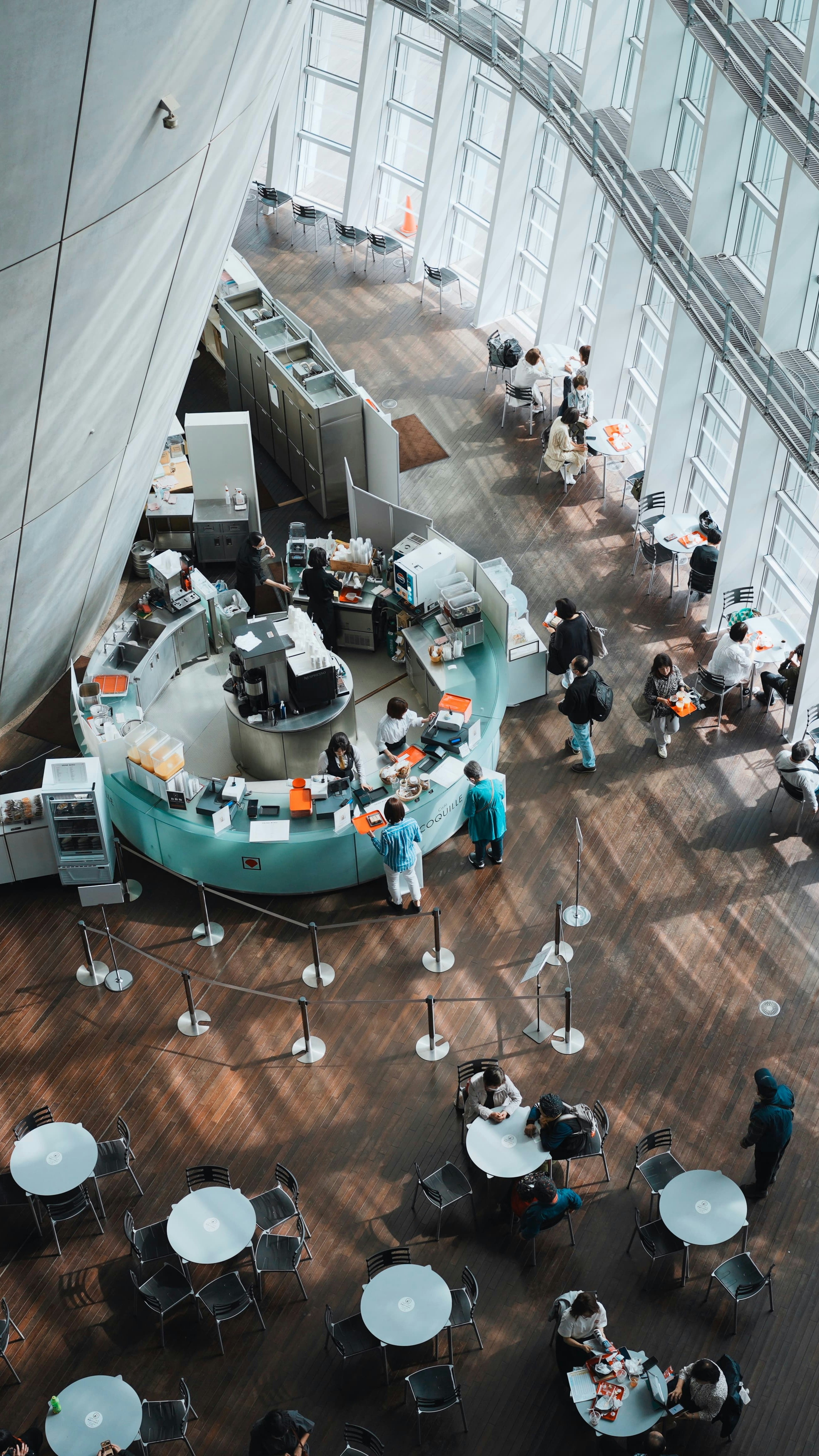 People at a cafe are served at the counter.
