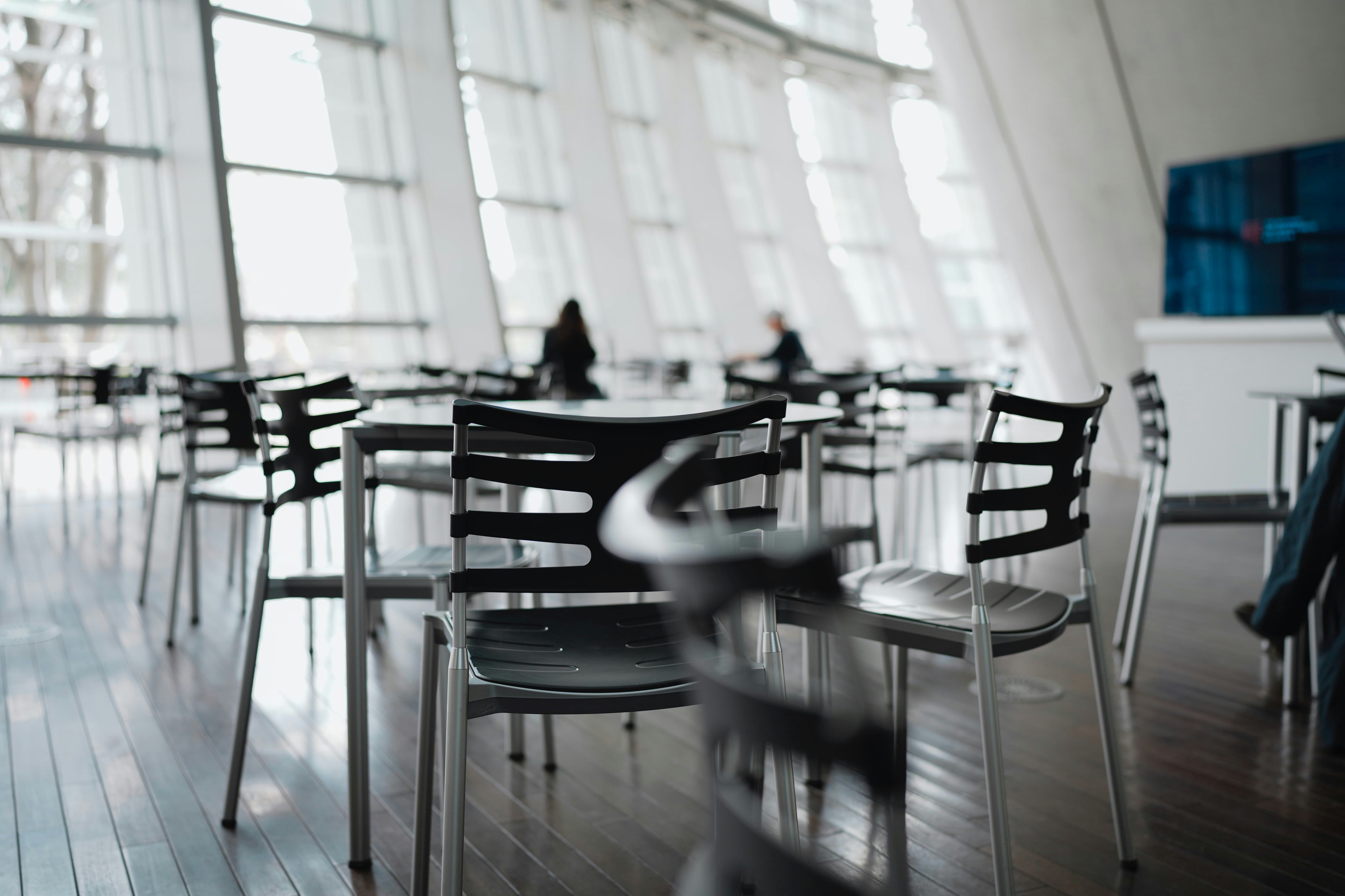 A restaurant interior with chairs and large windows.