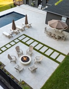 Luxury backyard features a pool, patio, and seating areas.