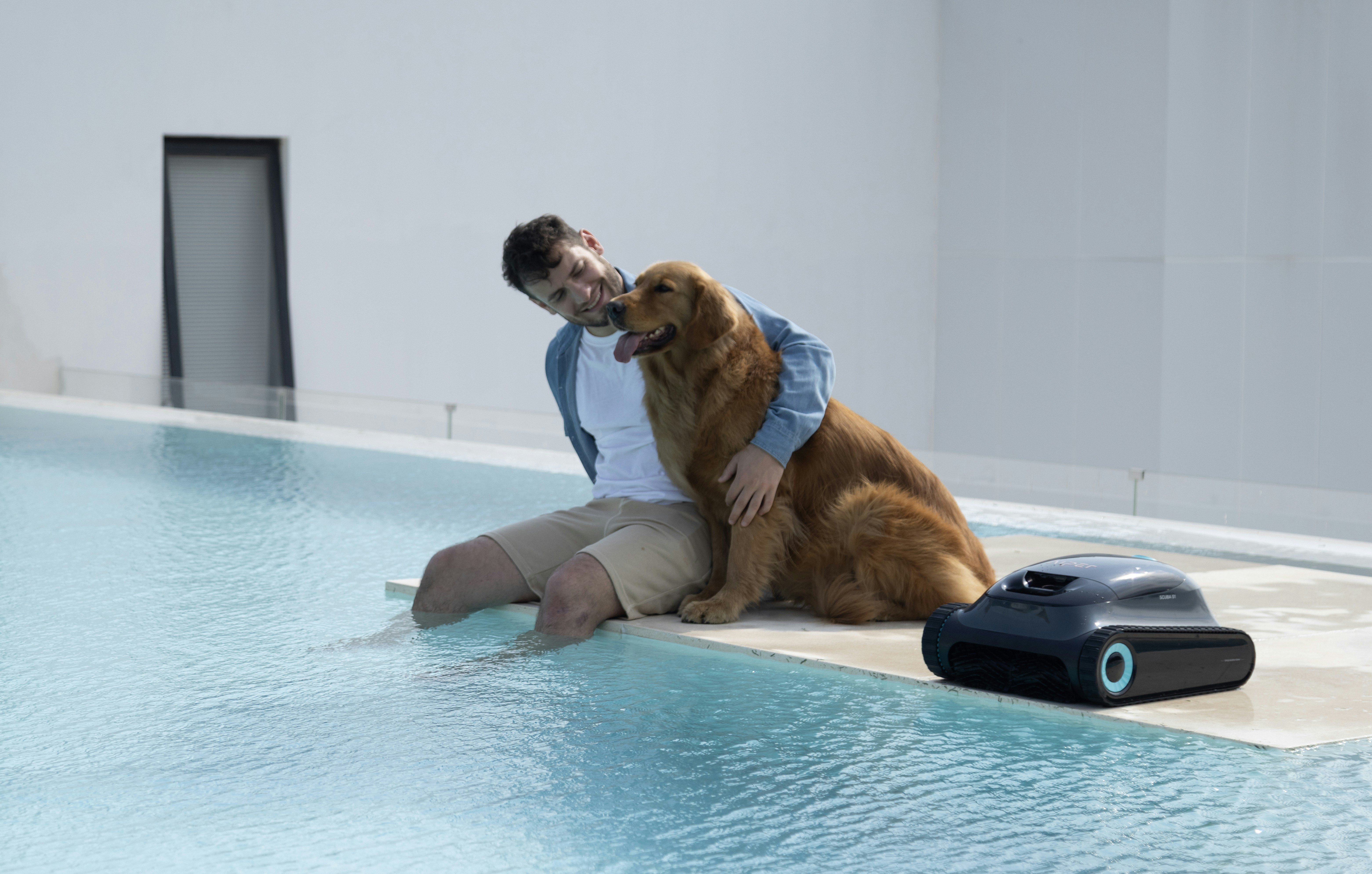 Man and dog relax by the pool with robot.