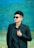 Stylish young man poses in a black suit.