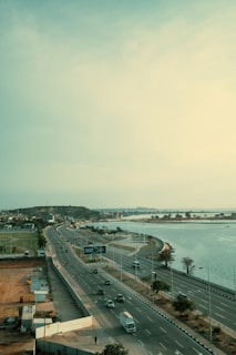 An elevated highway runs beside a body of water.
