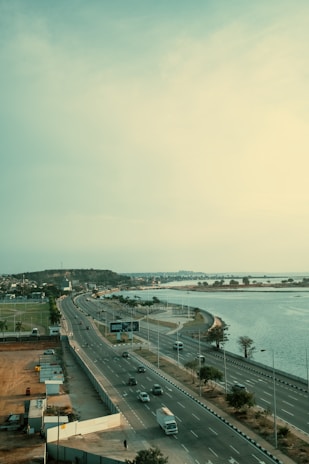 An elevated highway runs beside a body of water.