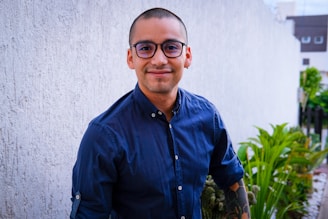 A man in glasses smiles for the camera.