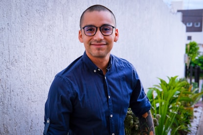 A man in glasses smiles for the camera.