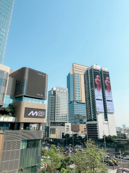 Cityscape with modern buildings under a clear blue sky.