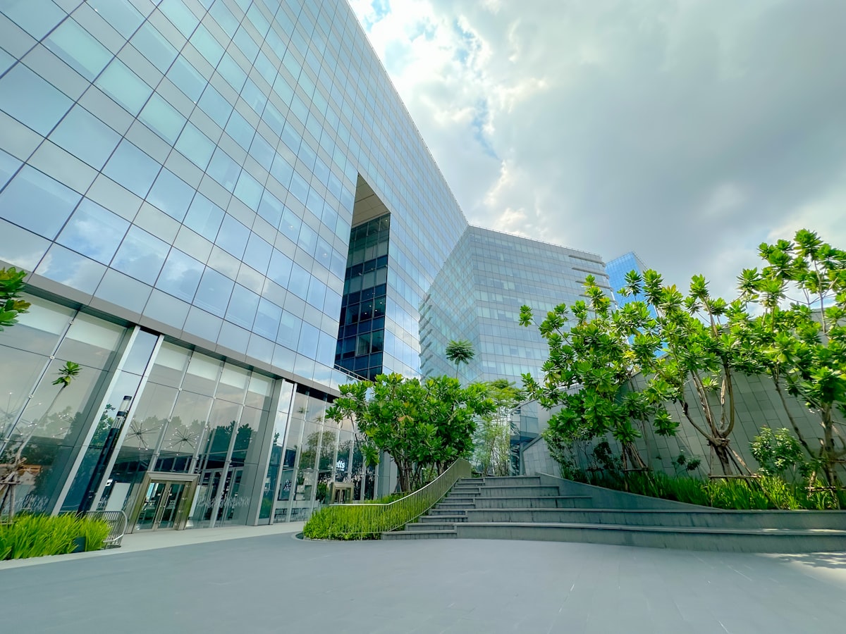 Modern glass office building with professionally maintained green landscaping