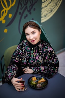 Woman in traditional dress enjoys a treat.