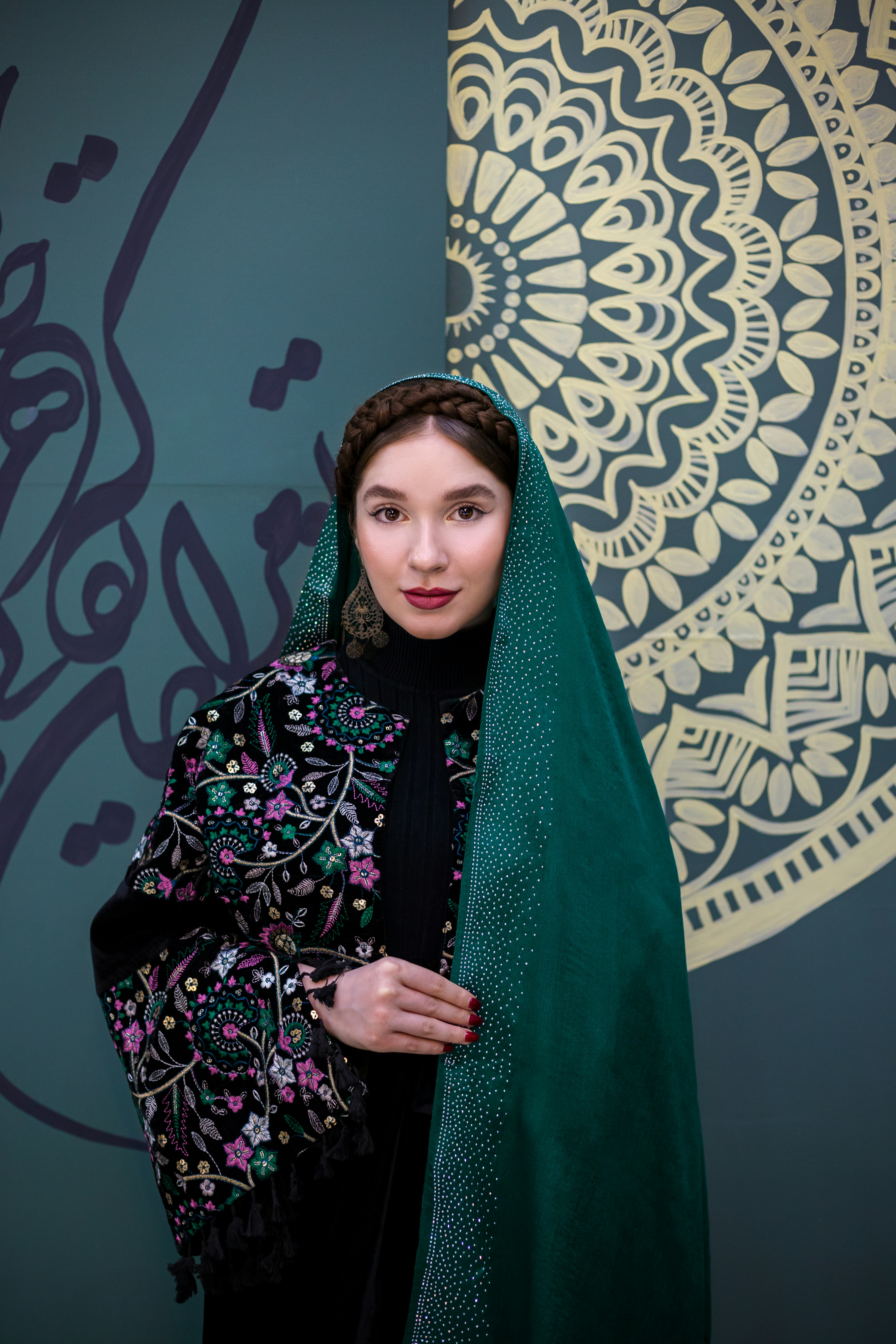 Wanita berpakaian tradisional berpose di depan seni.