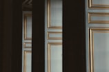 Elegant doors with gold trim are partially obscured.