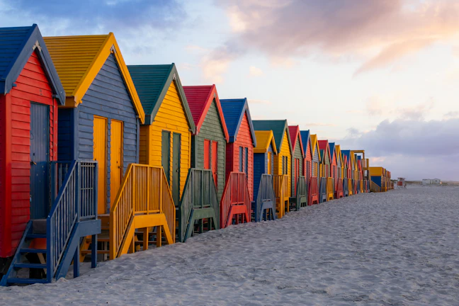 Colorful beach huts line the sandy shore.