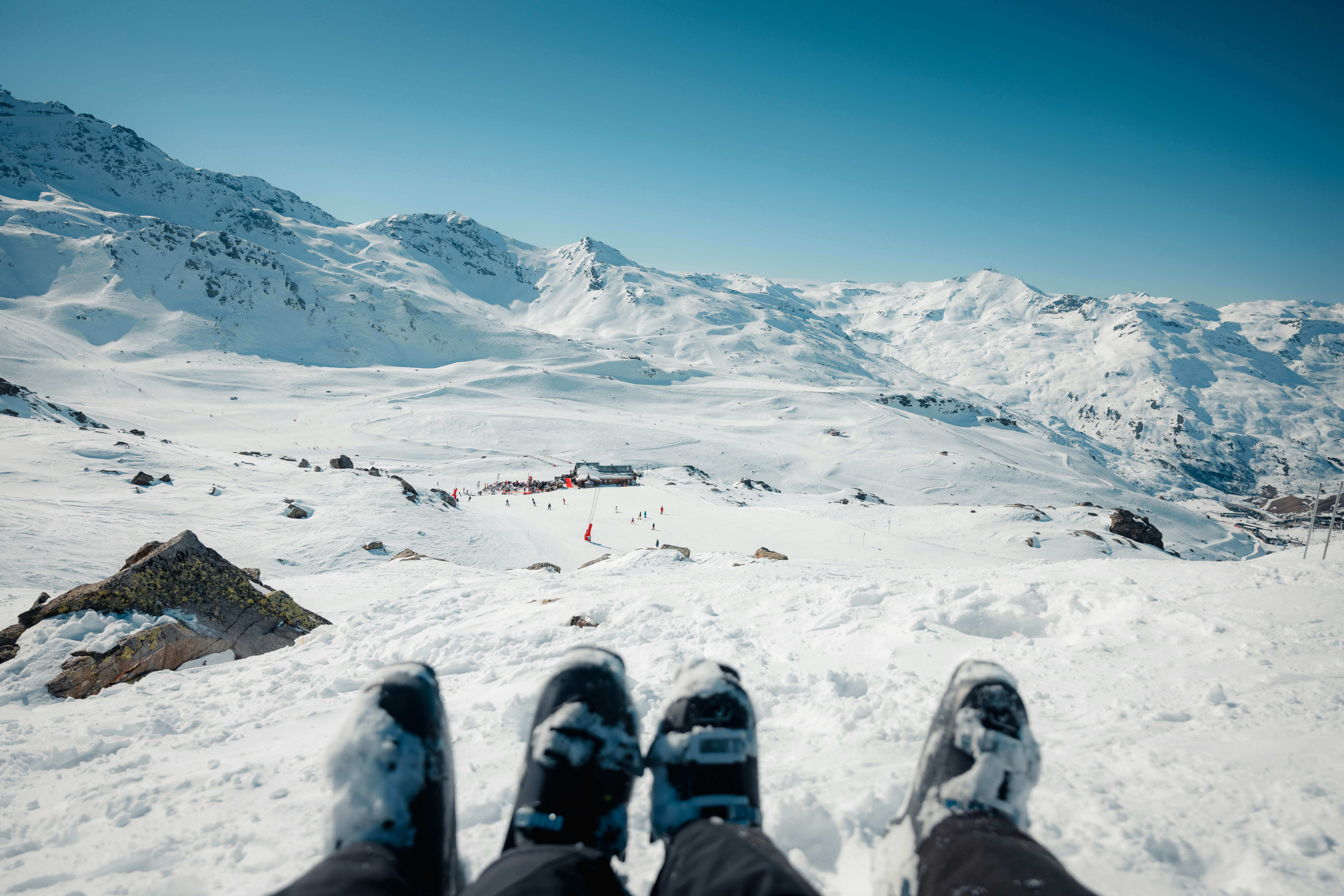 Ski boots with a snow-covered mountain view.