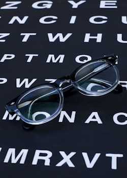 Glasses sit on an eye chart.
