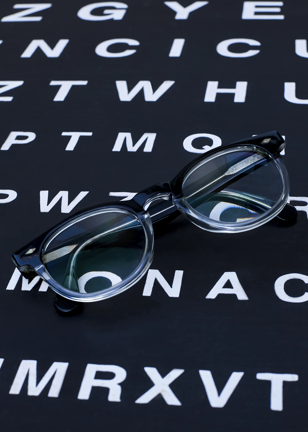 Eyeglasses resting on an eye chart