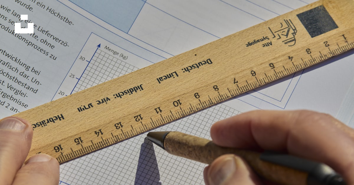 Someone is drawing a graph with a ruler and pen. photo – Free School ...