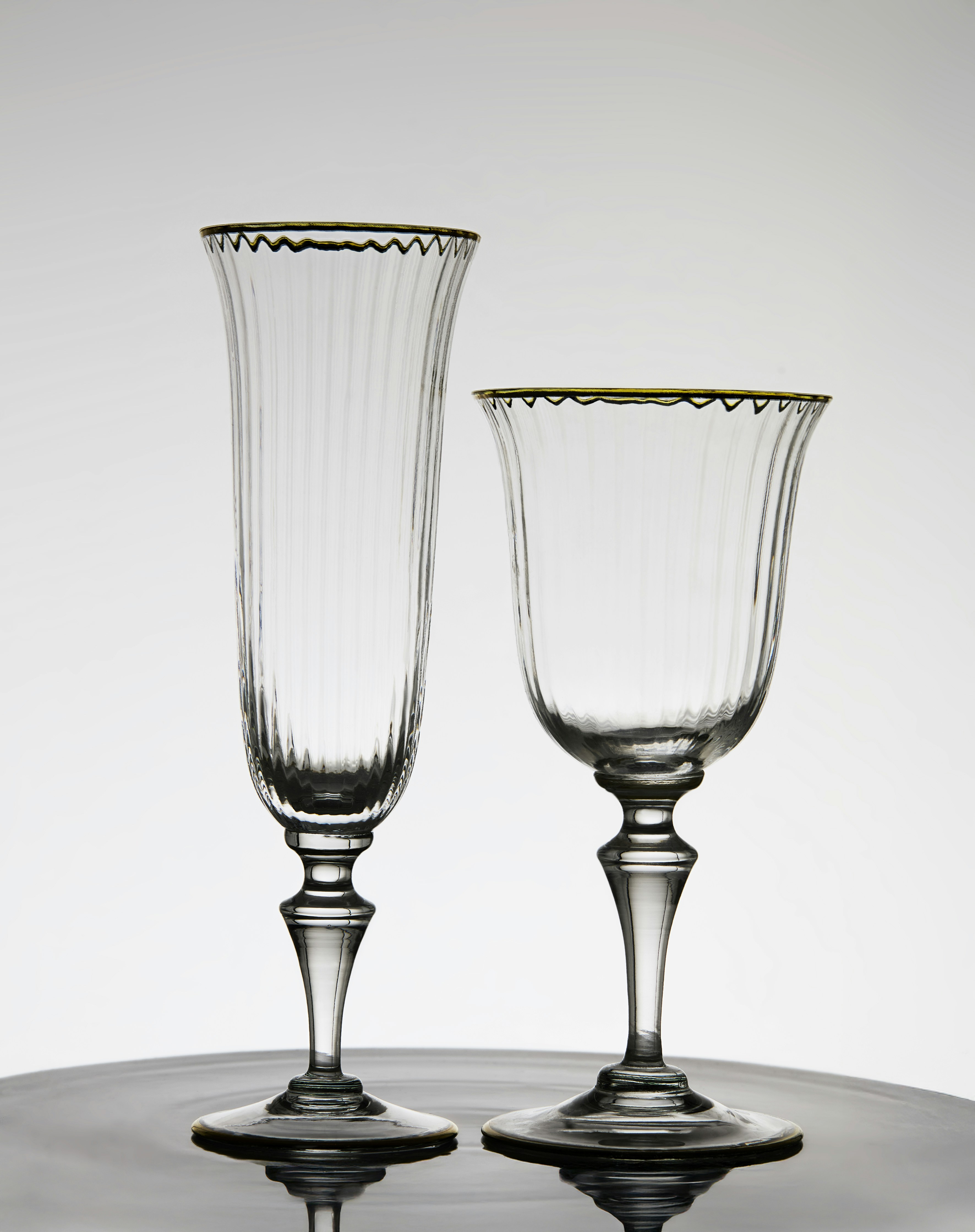 Two elegant champagne glasses are side by side.