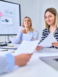 People review documents in a bright office setting.