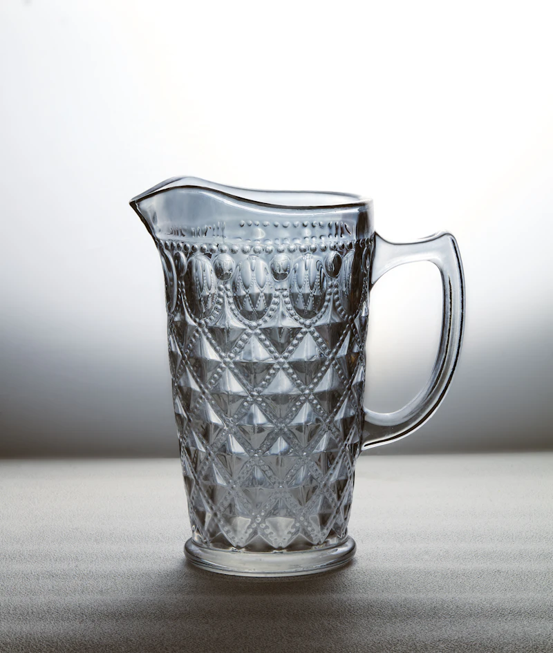 Crystal water pitcher on an elegant dinner table