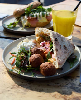 Delicious breakfast plates with bagels and juice.