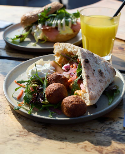 Delicious breakfast plates with bagels and juice.