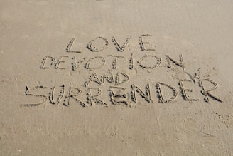Love, devotion and surrender are written in sand.